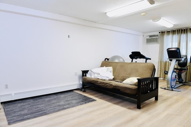 interior space with a baseboard radiator, light wood-type flooring, and a wall unit AC