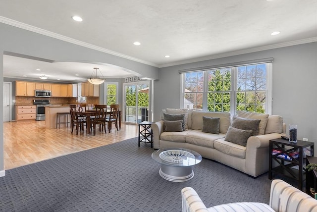 57 Bouffard Dr, Marlborough, MA 01752 - living room featuring arched walkways, recessed lighting, ornamental molding, and light wood-type flooring