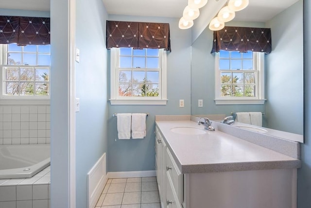 57 Bouffard Dr, Marlborough, MA 01752 - full bath featuring a healthy amount of sunlight, tile patterned floors, baseboards, and a relaxing tiled tub