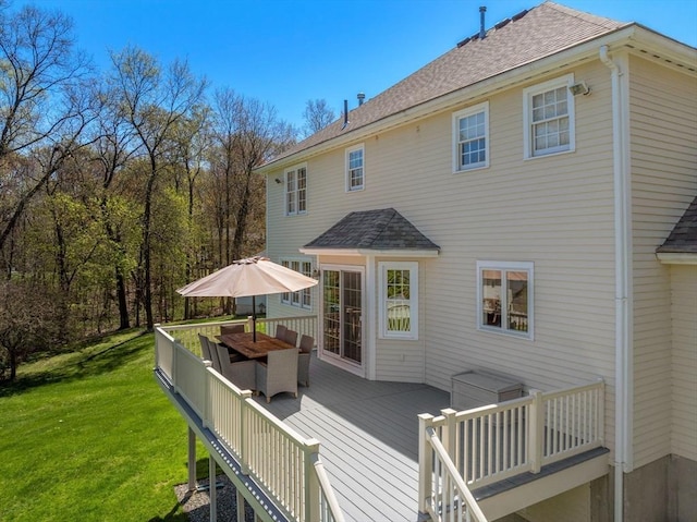 57 Bouffard Dr, Marlborough, MA 01752 - rear view of house featuring outdoor dining area, roof with shingles, a wooden deck, and a yard