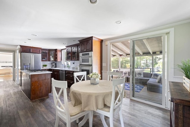 dining space with recessed lighting, ornamental molding, and wood finished floors