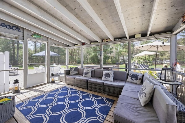 sunroom / solarium featuring beamed ceiling and outdoor lounge area