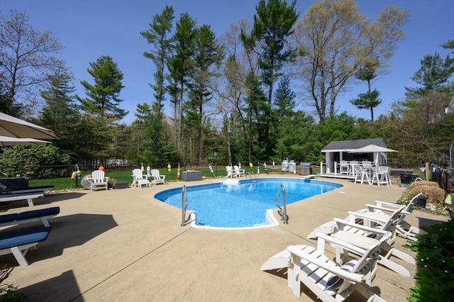 view of swimming pool featuring a patio, fence, and a fenced in pool
