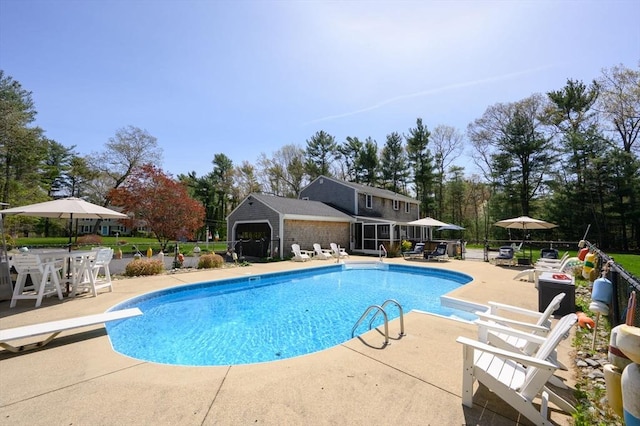 view of pool with a fenced in pool, fence, a patio, and a diving board