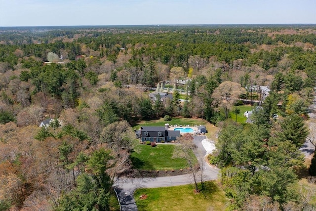 birds eye view of property featuring a view of trees