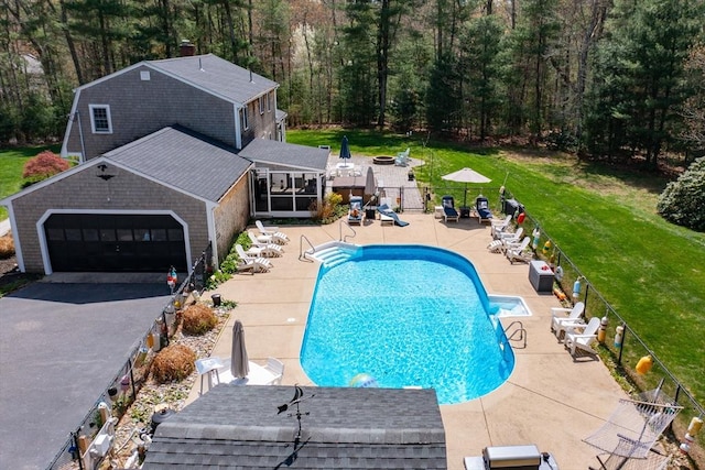 view of swimming pool with a lawn, a patio, fence, and a fenced in pool