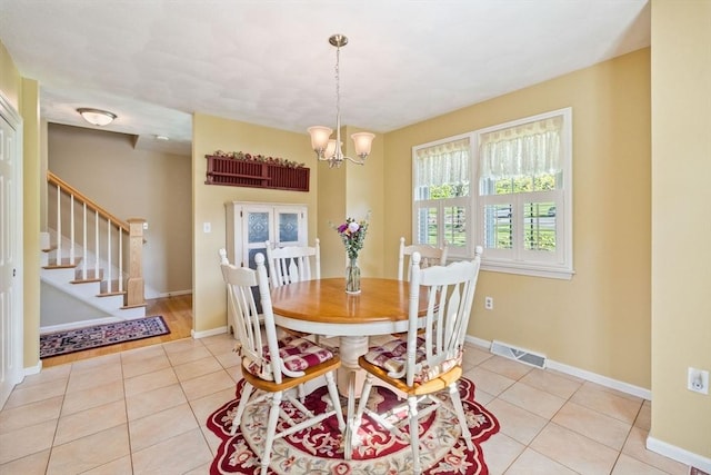 45 Washington St Unit B7, Methuen, MA 01844 - dining space with light tile patterned floors, stairway, a chandelier, and baseboards