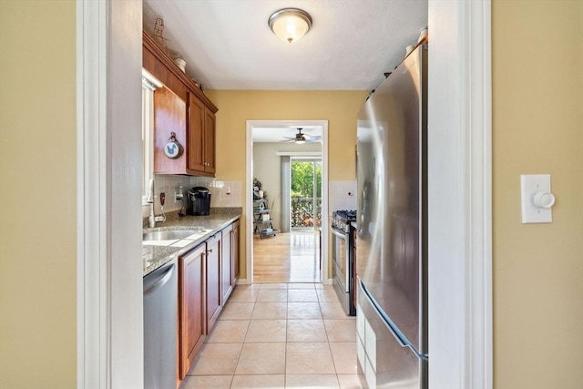 45 Washington St Unit B7, Methuen, MA 01844 - kitchen with stainless steel appliances, a sink, a ceiling fan, tasteful backsplash, and light tile patterned flooring