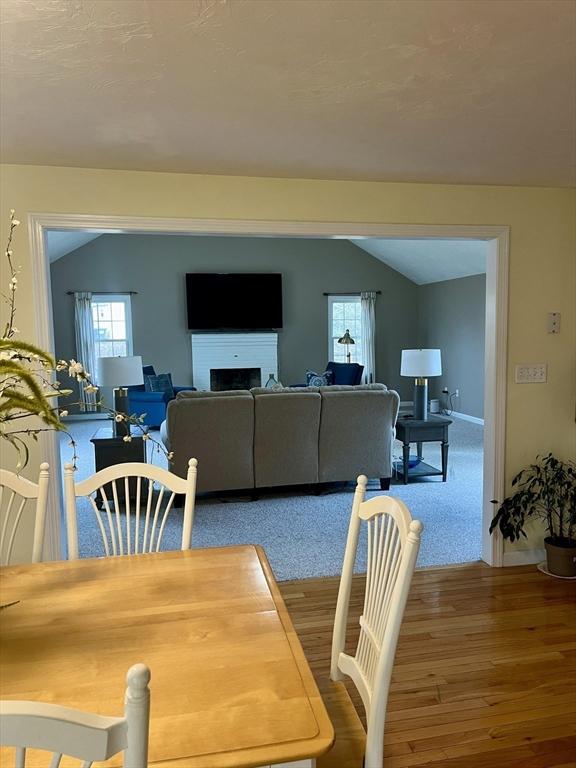 dining space featuring lofted ceiling and hardwood / wood-style flooring