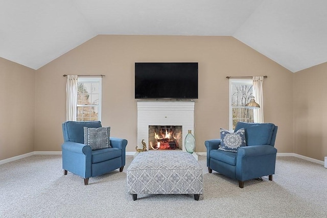 living area with carpet flooring and vaulted ceiling