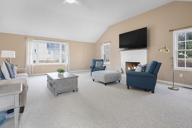 carpeted living room featuring ceiling fan and vaulted ceiling