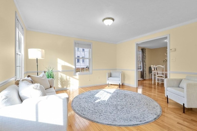 living room featuring crown molding and light hardwood / wood-style floors