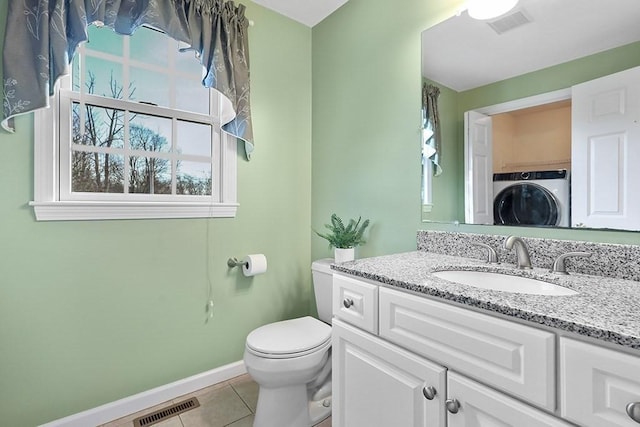 bathroom featuring tile patterned flooring, vanity, toilet, and stacked washer and clothes dryer