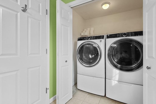 laundry area featuring light tile patterned flooring and washer and dryer