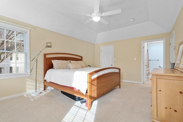 carpeted bedroom with a tray ceiling and ceiling fan