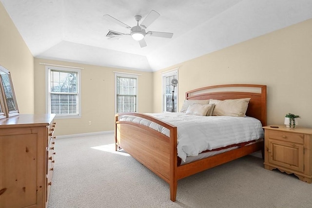 carpeted bedroom featuring a raised ceiling, ceiling fan, and lofted ceiling