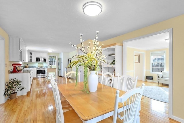 dining room with light hardwood / wood-style flooring and sink