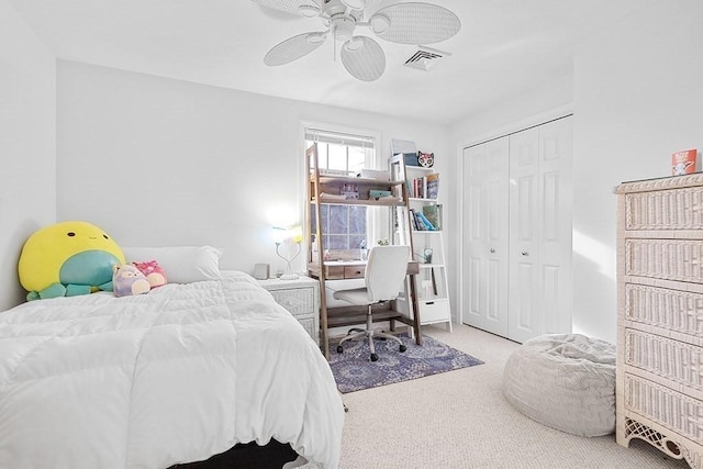 bedroom with light carpet, a closet, and ceiling fan