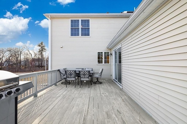 wooden terrace with a grill