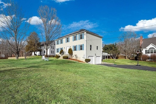 exterior space featuring a garage and a front lawn