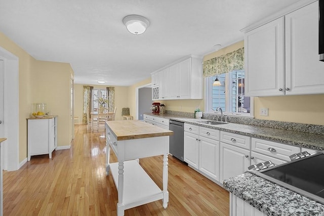 kitchen with white cabinetry, dishwasher, and sink