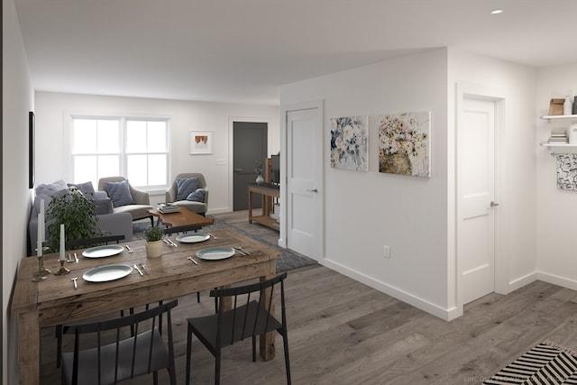 dining space with wood-type flooring