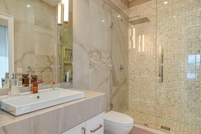 290 Massapoag Rd, Tyngsborough, MA 01879 - bathroom featuring a stall shower, toilet, tile walls, and vanity