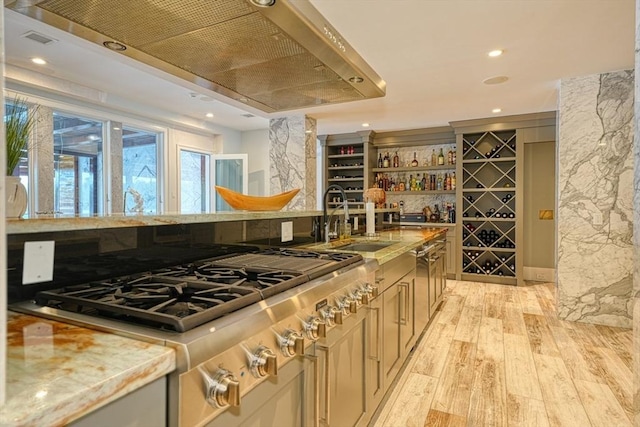 290 Massapoag Rd, Tyngsborough, MA 01879 - kitchen with stainless steel gas stovetop, a sink, light wood-style flooring, custom exhaust hood, and recessed lighting