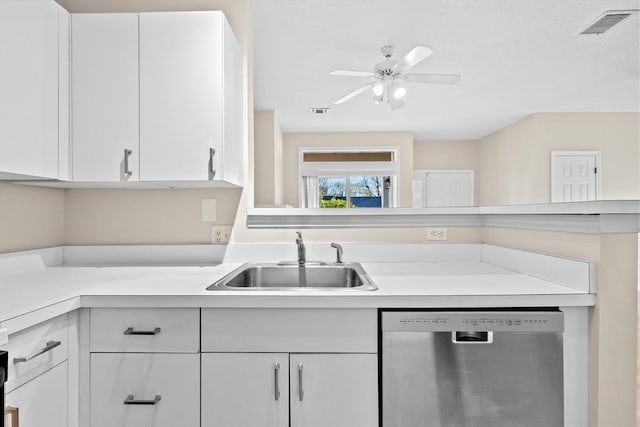 kitchen featuring white cabinets, a sink, light countertops, stainless steel dishwasher, and visible vents