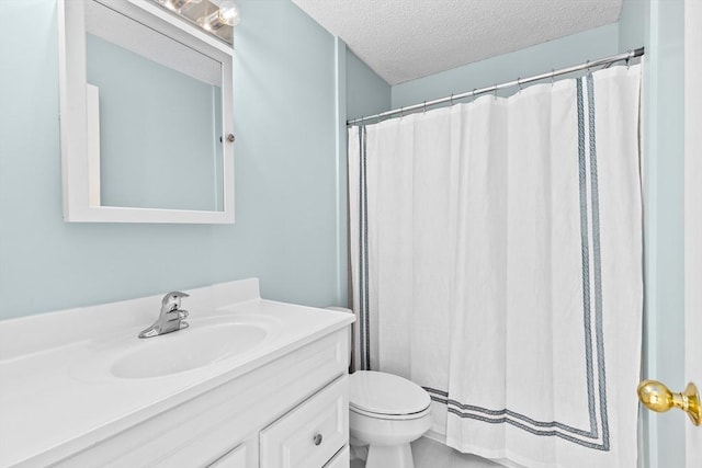 bathroom with vanity, a textured ceiling, curtained shower, and toilet