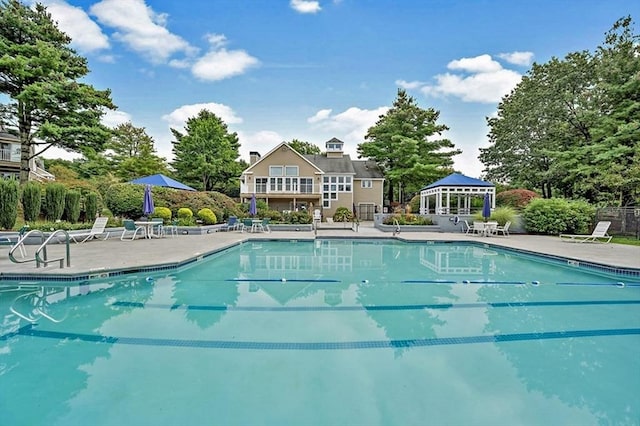 pool with a gazebo and a patio area