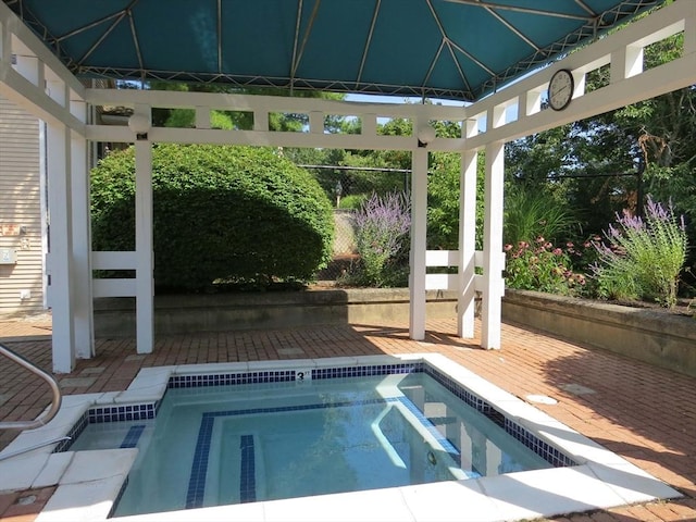 view of swimming pool featuring an in ground hot tub, a gazebo, and a deck