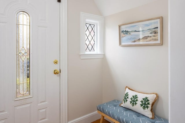 interior space featuring baseboards and lofted ceiling