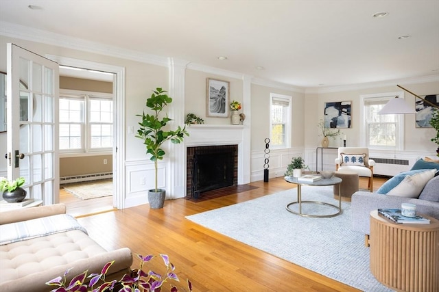 living area featuring ornamental molding, baseboard heating, and radiator