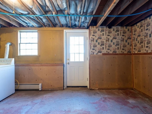 basement featuring baseboard heating and washer / clothes dryer