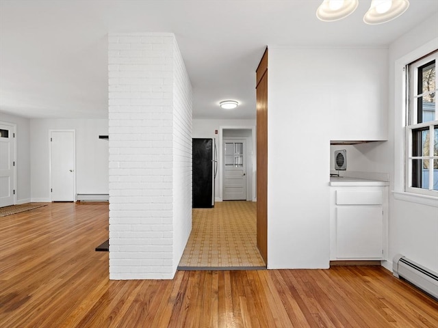 hall featuring light hardwood / wood-style floors and a baseboard heating unit