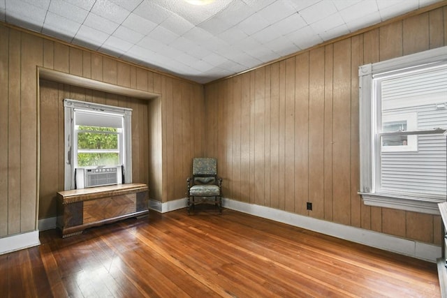 23 Highland Rd, Somerville, MA 02144 - unfurnished room with hardwood / wood-style flooring, wood walls, and cooling unit