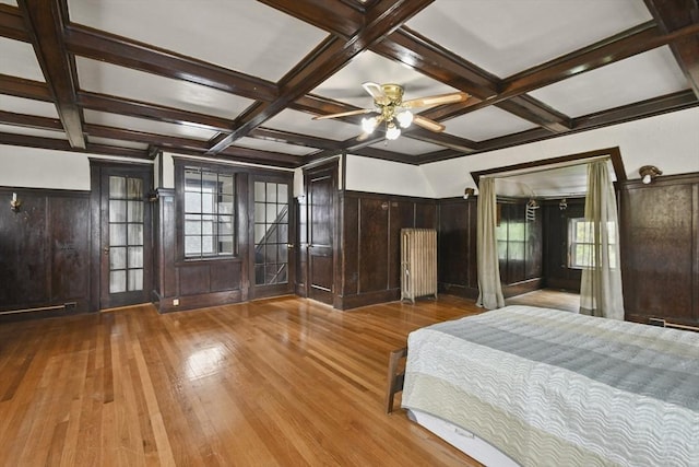 23 Highland Rd, Somerville, MA 02144 - unfurnished bedroom with hardwood / wood-style floors, beamed ceiling, coffered ceiling, a wainscoted wall, and radiator heating unit