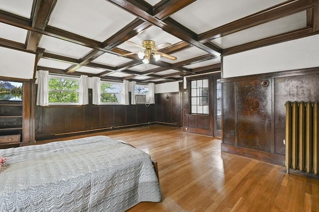 23 Highland Rd, Somerville, MA 02144 - bedroom with radiator, light wood-style flooring, beamed ceiling, wainscoting, and wood walls