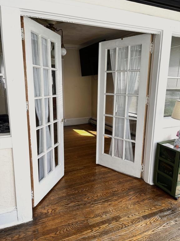 23 Highland Rd, Somerville, MA 02144 - doorway featuring wood finished floors and baseboards