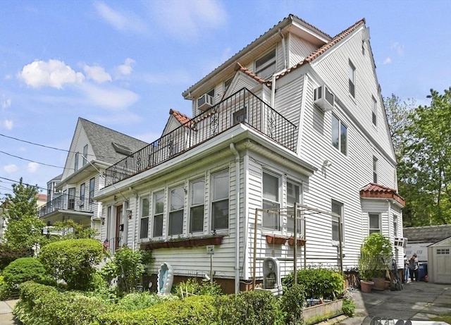 23 Highland Rd, Somerville, MA 02144 - view of home's exterior with a balcony, cooling unit, and a patio area