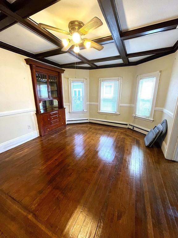 23 Highland Rd, Somerville, MA 02144 - unfurnished living room with coffered ceiling, a ceiling fan, hardwood / wood-style flooring, plenty of natural light, and beamed ceiling