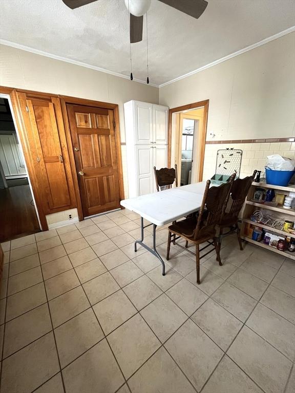 23 Highland Rd, Somerville, MA 02144 - dining space featuring ceiling fan, crown molding, and light tile patterned floors