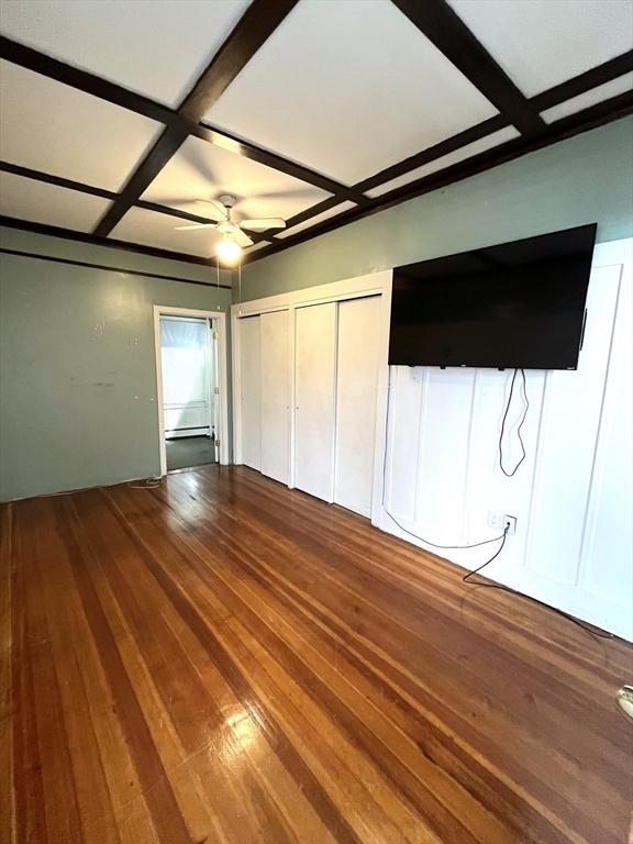 23 Highland Rd, Somerville, MA 02144 - unfurnished bedroom featuring coffered ceiling, wood-type flooring, beamed ceiling, and a ceiling fan