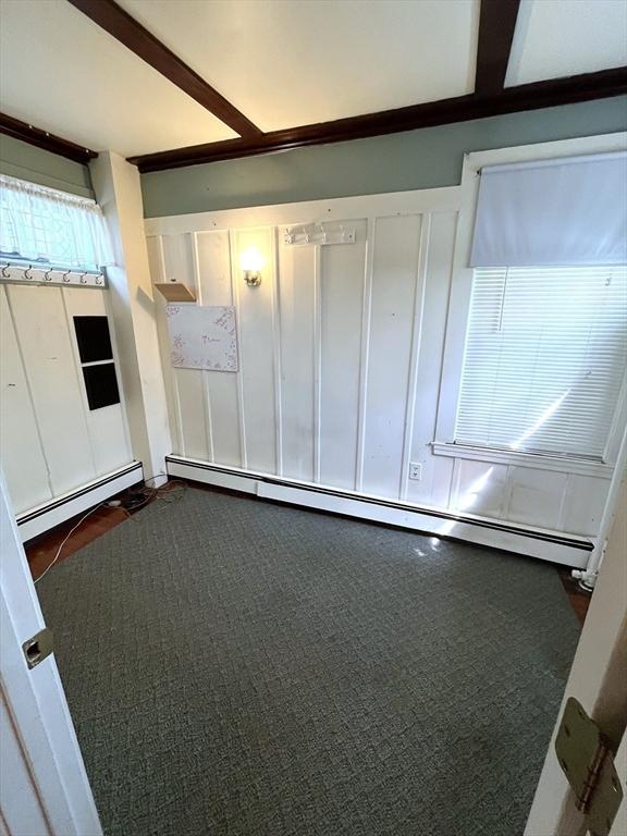23 Highland Rd, Somerville, MA 02144 - spare room featuring a baseboard heating unit