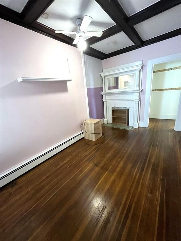 23 Highland Rd, Somerville, MA 02144 - unfurnished living room featuring coffered ceiling, a ceiling fan, hardwood / wood-style flooring, a fireplace, and baseboard heating