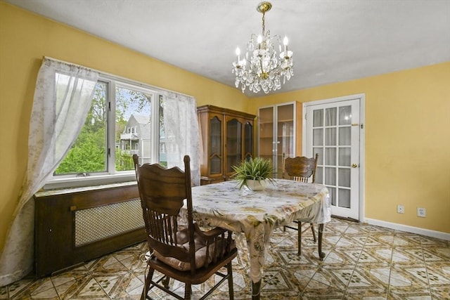 23 Highland Rd, Somerville, MA 02144 - dining space featuring a chandelier and radiator heating unit