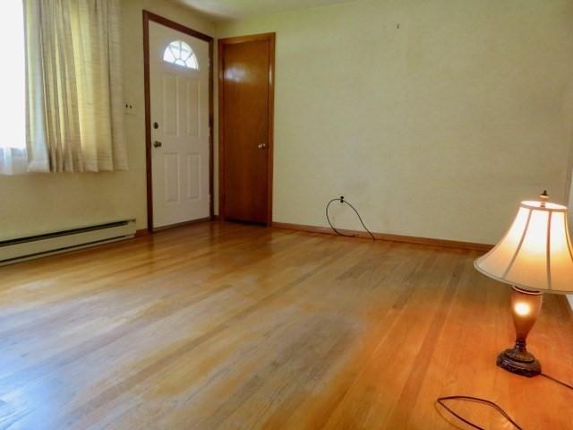 580 New Ludlow Rd, Chicopee, MA 01020 - foyer entrance featuring wood finished floors and baseboard heating