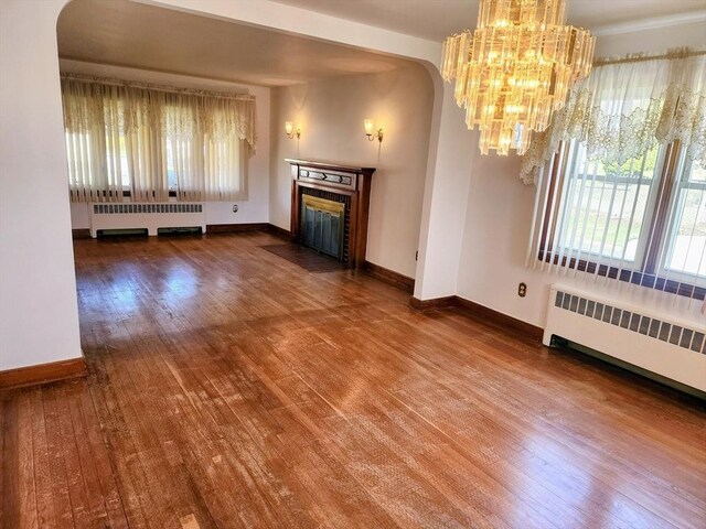 55 Kilburn St, Revere, MA 02151 - unfurnished living room with radiator, wood finished floors, and baseboards