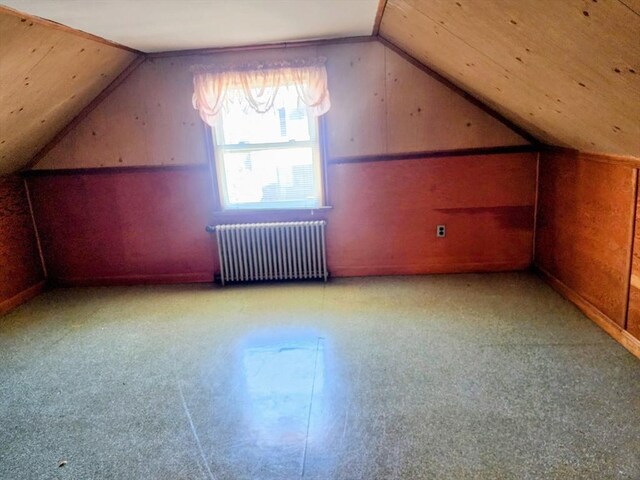 55 Kilburn St, Revere, MA 02151 - additional living space with radiator, wood walls, and lofted ceiling